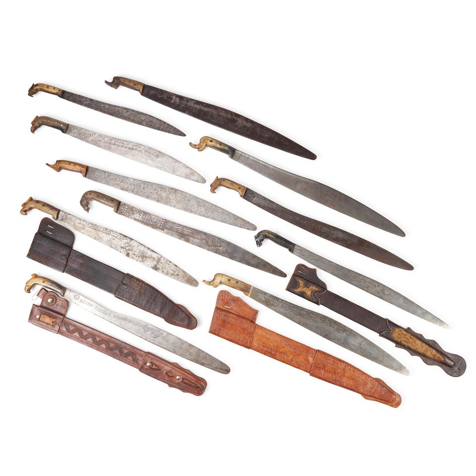ELEVEN INSCRIBED MEXICAN REVOLUTIONARY PERIOD MACHETES,: ELEVEN INSCRIBED MEXICAN REVOLUTIONARY PERIOD MACHETES, early 20th century. With carved horn figural handles and blades inscribed with patriotic inscriptions, four with leather scabbards. Overall lg.