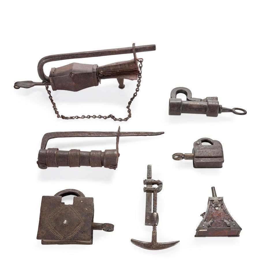 SEVEN 17TH CENTURY GUN IMPLEMENTS AND PADLOCKS.: SEVEN 17TH CENTURY GUN IMPLEMENTS AND PADLOCKS. Including a combination screwdriver and spring vice; a small triangular leather covered powder flask; and four iron padlocks. Overall lg. to 14 1/2 in.