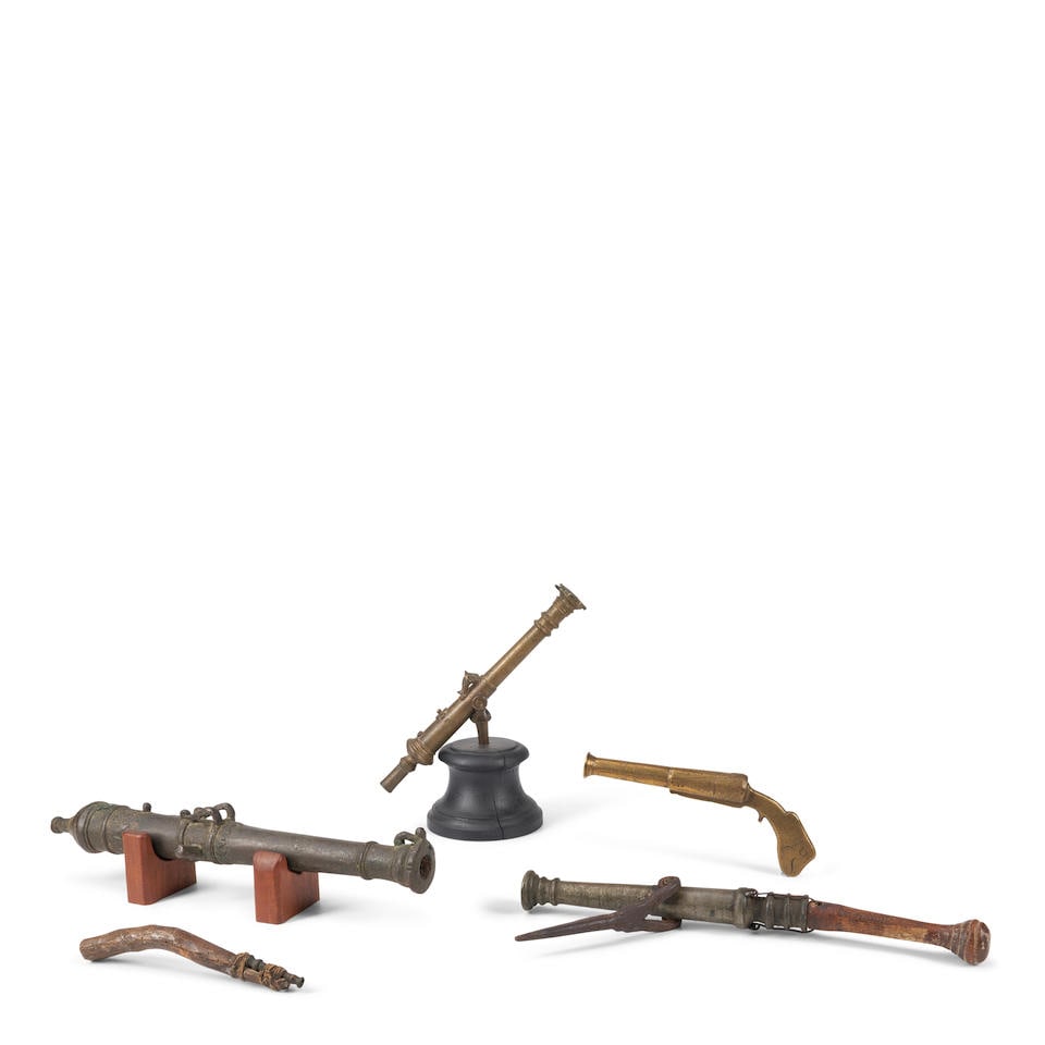 FIVE EARLY MINIATURE BRONZE CANNON.: FIVE EARLY MINIATURE BRONZE CANNON. 17th-19th century. Including three Lantaka guns and two small toy cannon. Overall lg. to 17 1/2 in. Footnotes: Literature The small all brass engraved gun and the L