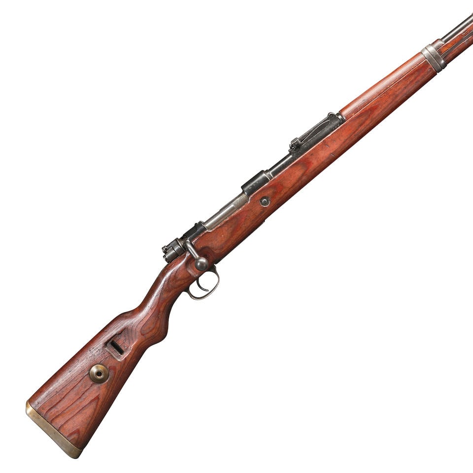 A WORLD WAR II GERMAN MAUSER K98 BOLT ACTION RIFLE, Curio or Relic firearm: A WORLD WAR II GERMAN MAUSER K98 BOLT ACTION RIFLE, 1940. Serial number 5075g, 7.92x57mm, refinished barrel and receiver with intact German military markings, adjustable rear sight and laminate stock,