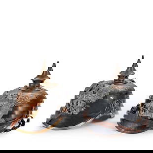 TWO WORLD WAR I GERMAN/PRUSSIAN HELMETS.: TWO WORLD WAR I GERMAN/PRUSSIAN HELMETS. A pickelhaube with spread wing eagle plate on the front and spike on the top; and a Baden leather helmet with griffin plate on the front and tinned spike on th