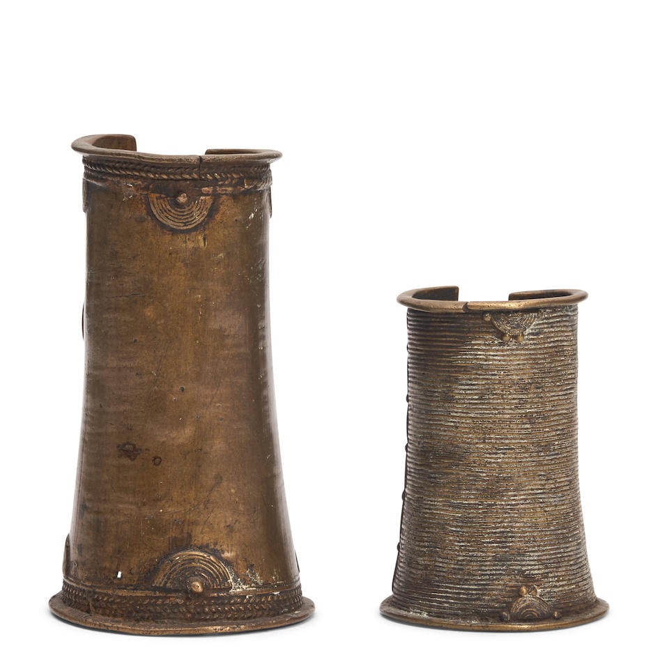TWO AFRICAN BRASS CUFF BRACELETS: TWO AFRICAN BRASS CUFF BRACELETS Both with etched stylized designs, 6 1/2' largest cuff length. Footnotes: OVERALL CONDITION: Fair. Patina and surface wear throughout. Surface grime. Cracks and damage