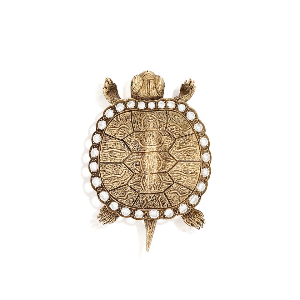 A GOLD AND DIAMOND TURTLE BROOCH: A GOLD AND DIAMOND TURTLE BROOCH Designed as a turtle with textured shell, bordered by full-cut diamonds, and circular-cut green stone eyes, weight 12.0 dwt, measures 1 3/4 x 1 1/4 in. For further in
