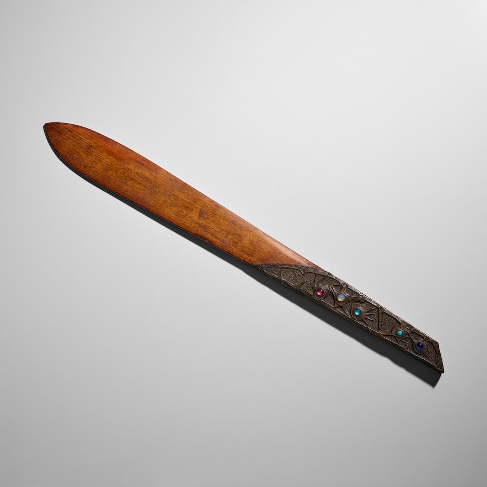 ALFRED DAGUET (1875-1942) Page Turnercirca 1905mahogany, repousse copper, inset with polychrome ...: ALFRED DAGUET (1875-1942) Page Turner circa 1905 mahogany, repousse copper, inset with polychrome glass cabochons width 20 1.2in (52cm); depth 2in (5cm) Lot to be sold without reserve. This lot is sub