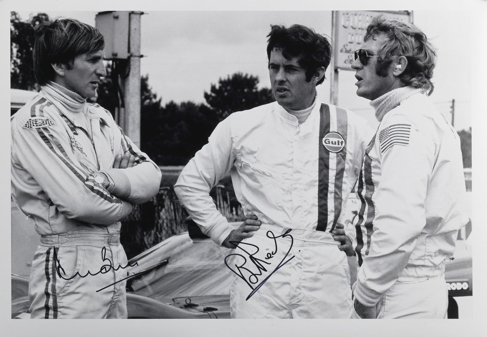 A motorsport photographic print signed by Derek Bell & Brian Redman,: A motorsport photographic print signed by Derek Bell & Brian Redman, comprising 'Steve McQueen Le Mans', 30 x 46cm, offered with a certificate of authenticity. Lot to be sold without reserve.