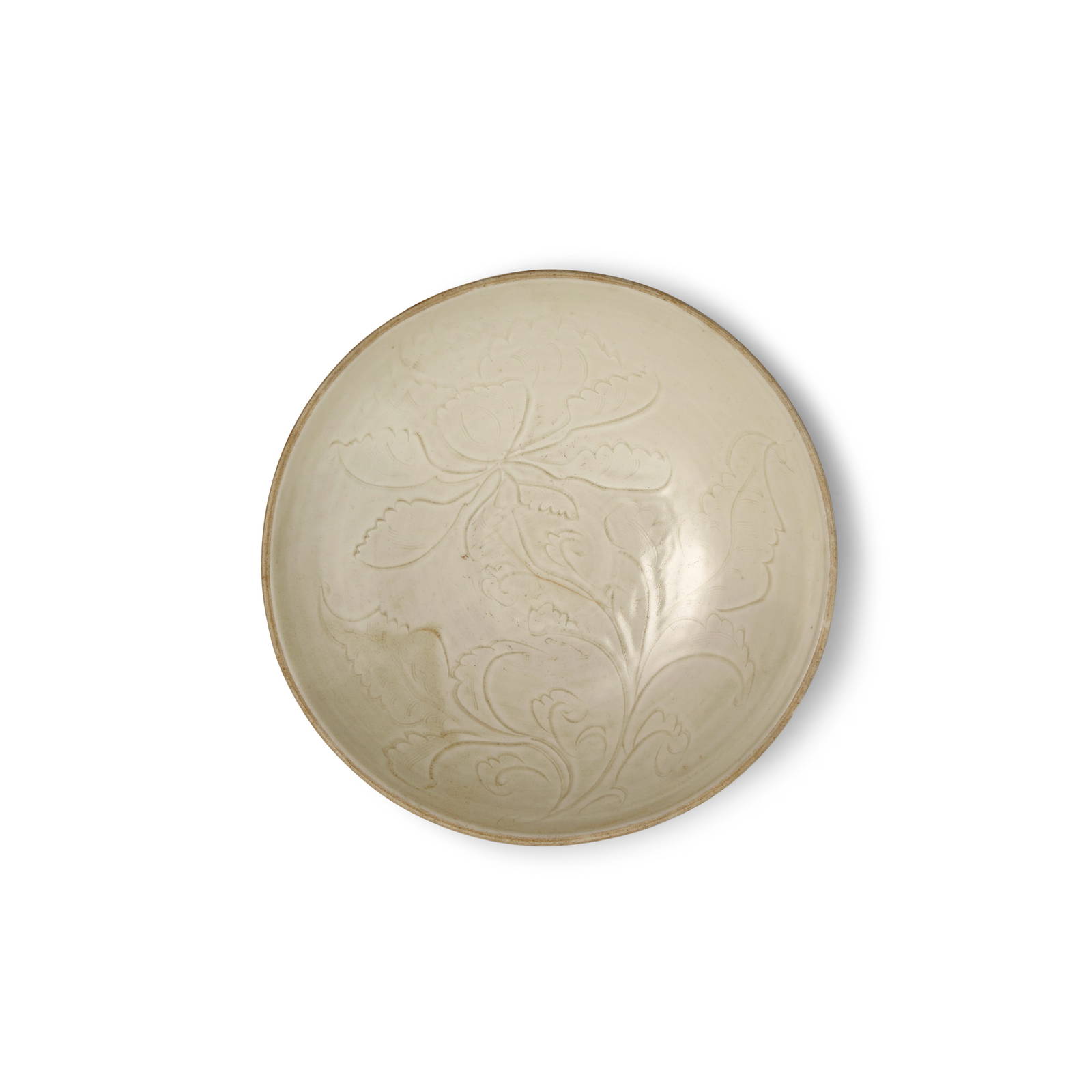 A CARVED DINGYAO 'PEONY' DISH Song Dynasty