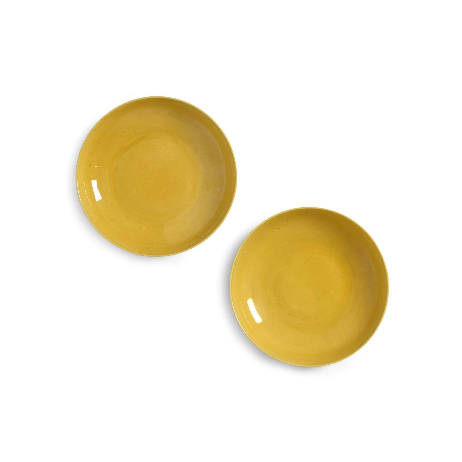 AN ELEGANT PAIR OF INCISED YELLOW-GLAZED 'FLORAL' SAUCER DISHES Yongzheng six-character marks an...