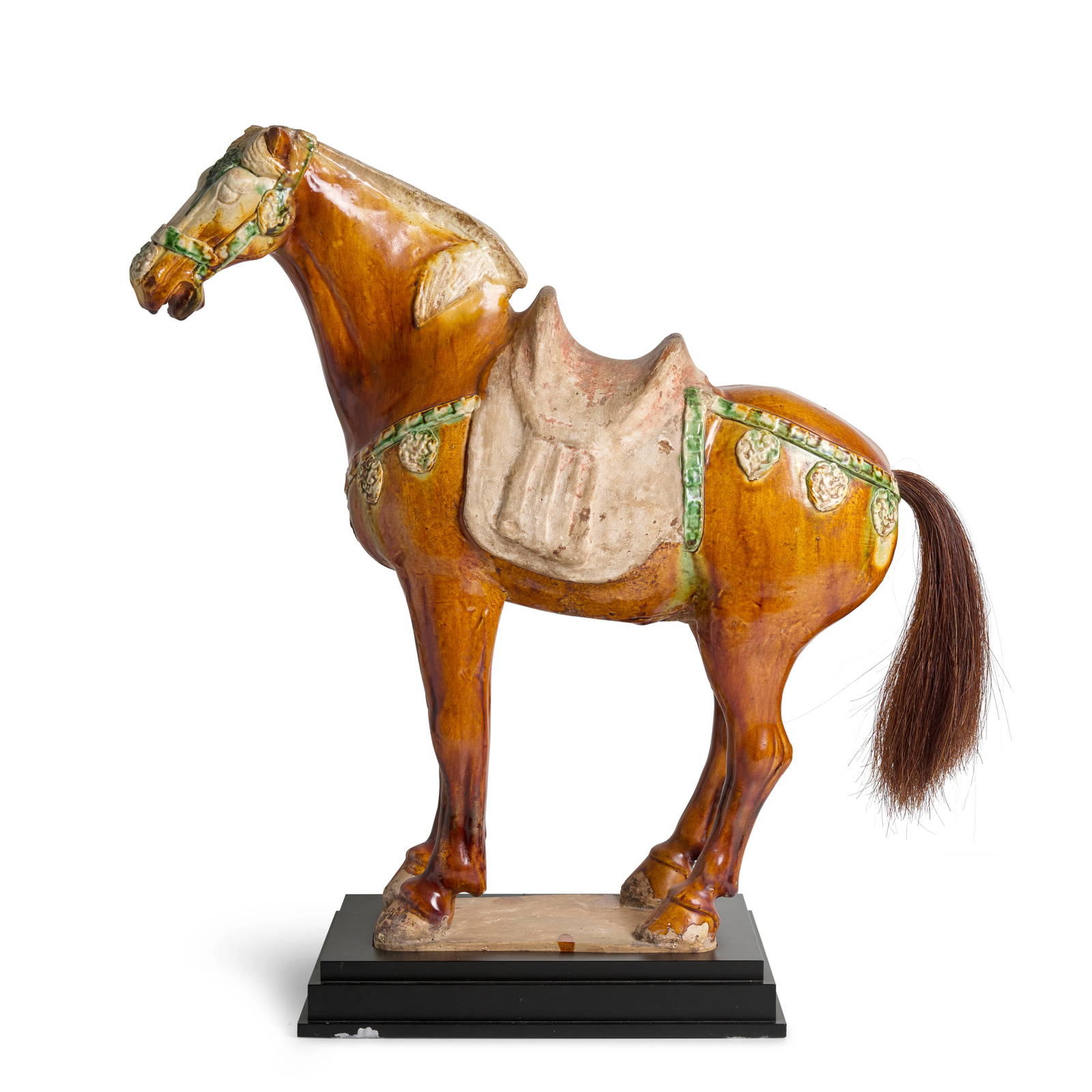 A SANCAI-GLAZED POTTERY CAPARISONED HORSE Tang Dynasty