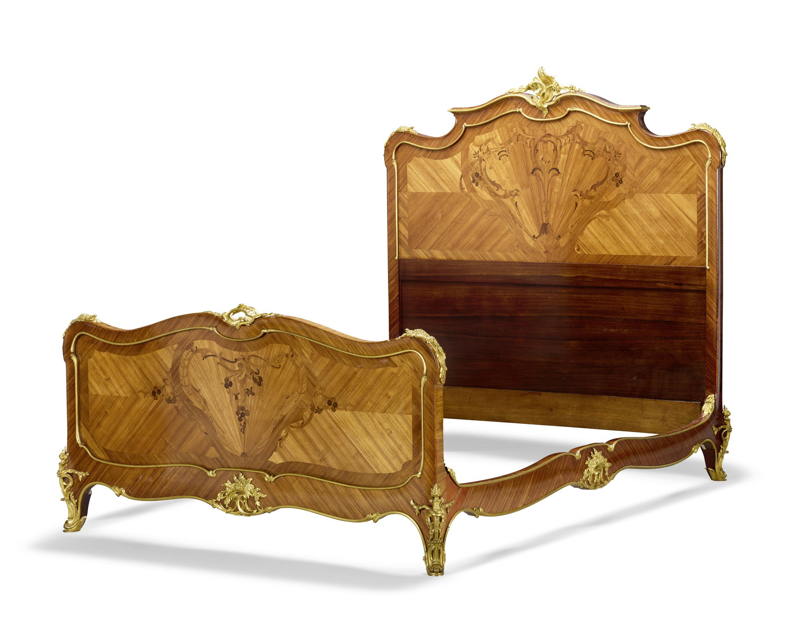 A French late 19th century kingwood, marquetry and gilt bronze mounted double bedIn the manner o...: A French late 19th century kingwood, marquetry and gilt bronze mounted double bed In the manner of Joseph-Emmanuel Zwiener (1848-1895), in the Louis XV style With a shaped headboard and conforming foo