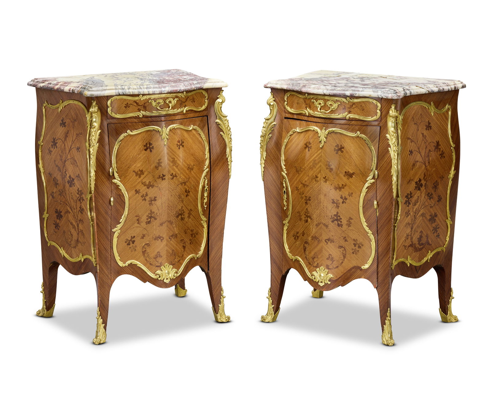 A pair of French early 20th century kingwood, marquetry and gilt bronze mounted bombé bedsi...: A pair of French early 20th century kingwood, marquetry and gilt bronze mounted bombé bedside cabinets In the manner of Joseph-Emmanuel Zwiener (1848-1895) The serpentine shaped marble tops above
