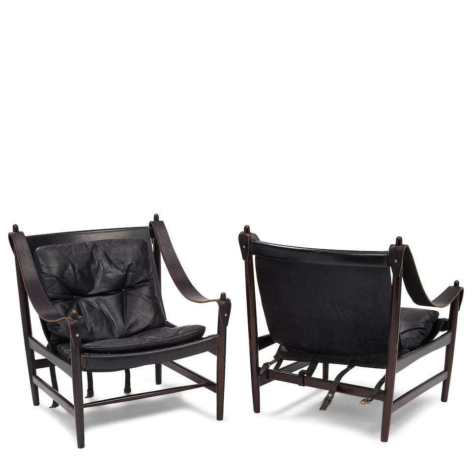 A PAIR OF BLACK LEATHER AND STAINED BEECHWOOD SAFARI CHAIRSIn the manner of Kaare Klint: A PAIR OF BLACK LEATHER AND STAINED BEECHWOOD SAFARI CHAIRS In the manner of Kaare Klint height 33 1/4in (84.5cm); width 29 1/2in (75cm); depth 28in (71cm) Footnotes: Condition reports are not provide