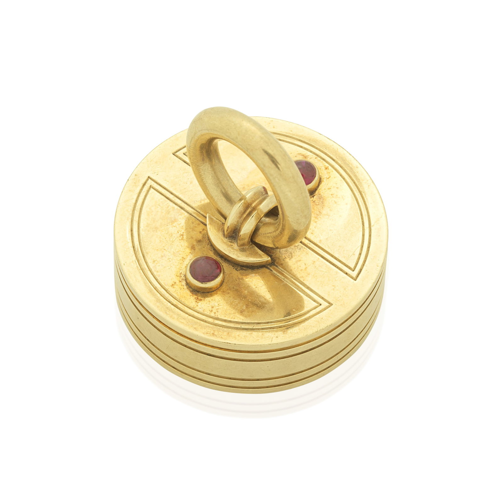 CARTIER: GOLD AND RUBY PILL BOX,: CARTIER: GOLD AND RUBY PILL BOX, 1947 Accented by ruby cabochons, mounted in 9 carat gold, signed Cartier London, maker's mark JC, numbered, London hallmark, diameter 3.0cm, maker's case