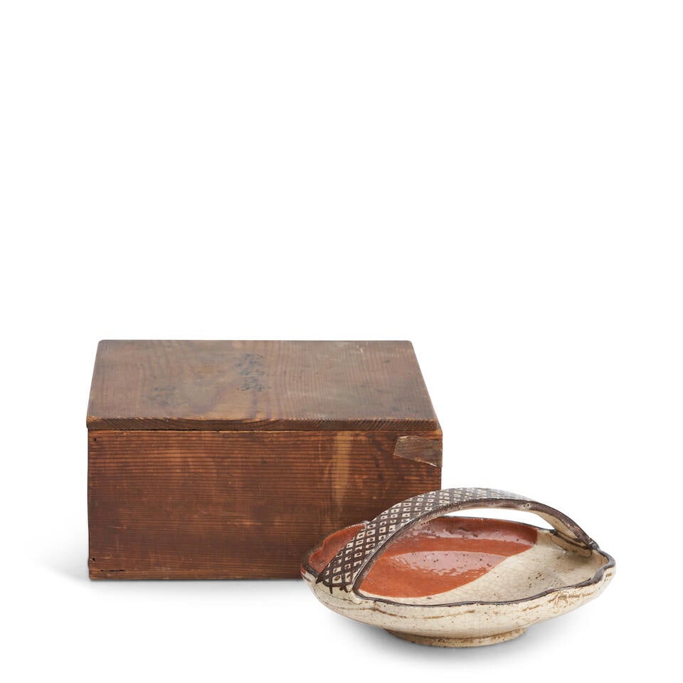 AN AKA-SHINO TEBACHI (CIRCULAR BOWL WITH HANDLE) Edo period (1615-1868), 19th century,