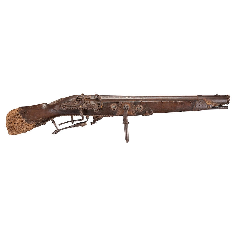A MATCHLOCK ESPIGNOLE WITH INSCRIPTION REFERENCING CHRISTOPHER COLUMBUS AND ICONOGRAPHY REPRESEN...: A MATCHLOCK ESPIGNOLE WITH INSCRIPTION REFERENCING CHRISTOPHER COLUMBUS AND ICONOGRAPHY REPRESENTING SPAIN. The 31 3/4 in., 1.19 caliber heavy octagon to round barrel octagonal at the breech with a lo
