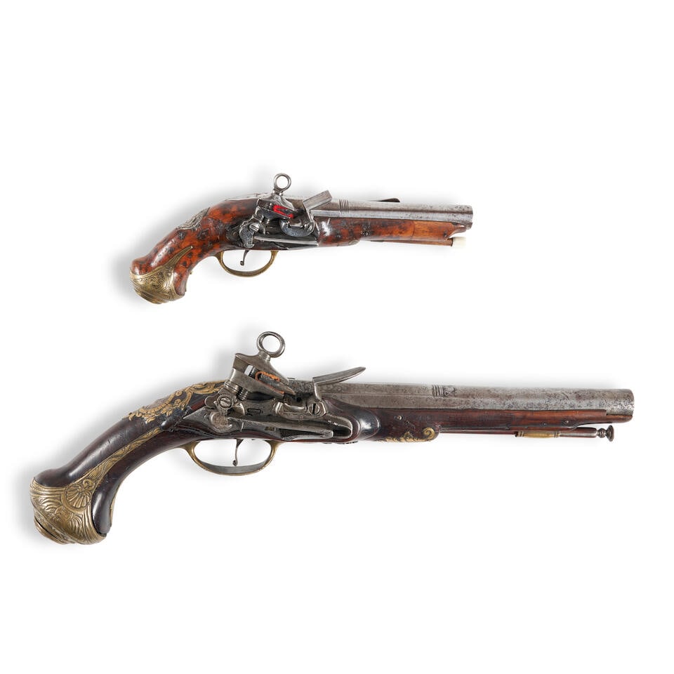 TWO SPANISH MIQUELET FLINTLOCK BELT PISTOLS,: TWO SPANISH MIQUELET FLINTLOCK BELT PISTOLS, 18th century. A pistol with a 9 in., .64 caliber barrel with Spanish maker's markings at the breech; miquelet lock; walnut stock and engraved brass furnitu