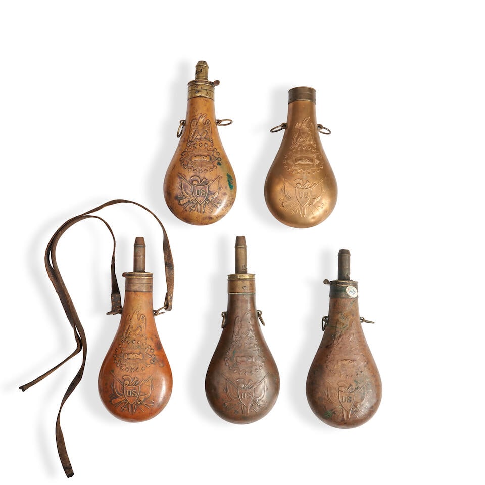 FIVE 19TH CENTURY EMBOSSED COPPER 'PEACE' POWDER FLASKS.: FIVE 19TH CENTURY EMBOSSED COPPER 'PEACE' POWDER FLASKS. All by Batty and dated 1847, 1848, two dated 1853, one lacking the spout (springs mostly lacking). For further information on this lot please v