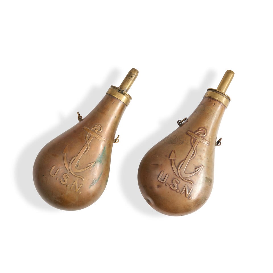 TWO U.S. NAVY 'FOULED ANCHOR' POWDER FLASKS.: TWO U.S. NAVY 'FOULED ANCHOR' POWDER FLASKS. The flasks with embossed copper bodies depicting a fouled anchor above 'U.S.N.' with suspension rings on the sides, the top with a brass spout, one marked