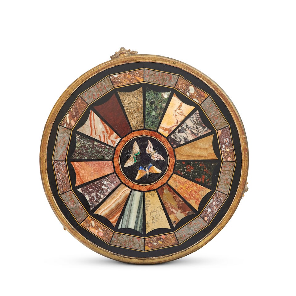 An early 19th century specimen marble pietra dura giltwood and gesso occasional table: An early 19th century specimen marble pietra dura giltwood and gesso occasional table The circular marble top inlaid with numerous radiating segments of assorted hardstone and marbles centred with thr