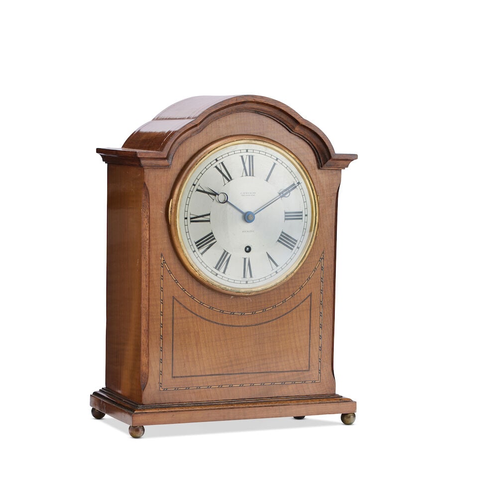 An early 20th century satinwood inlaid mantel clock By Zenith retailed by Catanachs Melbourne: An early 20th century satinwood inlaid mantel clock By Zenith retailed by Catanachs Melbourne The 6-inch silver dial with Roman numerals, twin train movement winding from one arbor striking a bell, st
