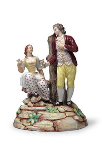 Groupe d'amoureux en porcelaine de Doccia, vers 1780 A Doccia group of lovers, circa 1780: Groupe d'amoureux en porcelaine de Doccia, vers 1780 A Doccia group of lovers, circa 1780 Representing a peasant boy extending flowers in his right hand to a seated peasant girl, she with puce
