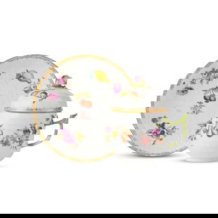 Tasse couverte et soucoupe en porcelaine de Meissen, vers 1750 A Meissen covered cup and saucer,...: Tasse couverte et soucoupe en porcelaine de Meissen, vers 1750 A Meissen covered cup and saucer, circa 1750 Decorated with polychrome fruits and flowers within relief-moulded scrollwork