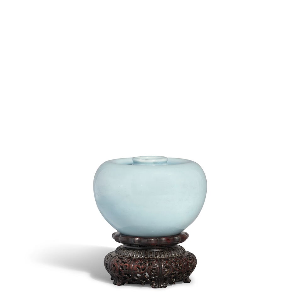 A CLAIR-DE-LUNE-GLAZED WATER POT, PINGGUO ZUN Kangxi mark, Republic period (fitted fabric box an...: A CLAIR-DE-LUNE-GLAZED WATER POT, PINGGUO ZUN Kangxi mark, Republic period 4 1/8in (10.5cm) diam (fitted fabric box and wood stand). Footnotes: 民國 天藍釉蘋果