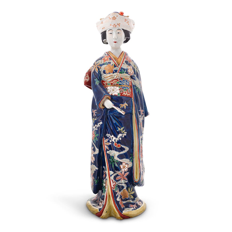 A JAPANESE GILT AND OVERGLAZE ENAMEL DECORATED KUTANI PORCELAIN FIGURE OF A STANDING BEAUTY Tais...