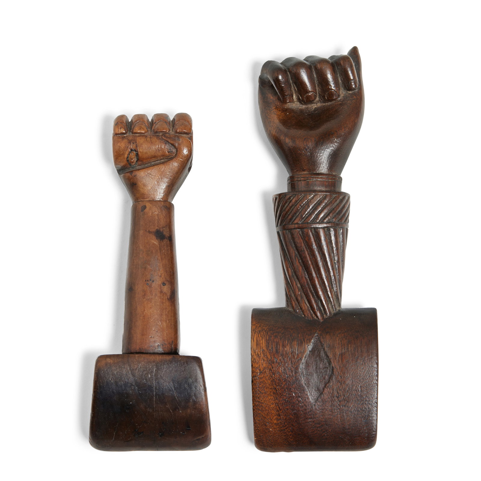 Three sailor-work treen items, English, mid 19th century, (3): Three sailor-work treen items, English, mid 19th century, comprising two mahogany sail makers seam rubbers each with clenched fist handle, and a sailor's tobacco box carved in the shape of a fish with
