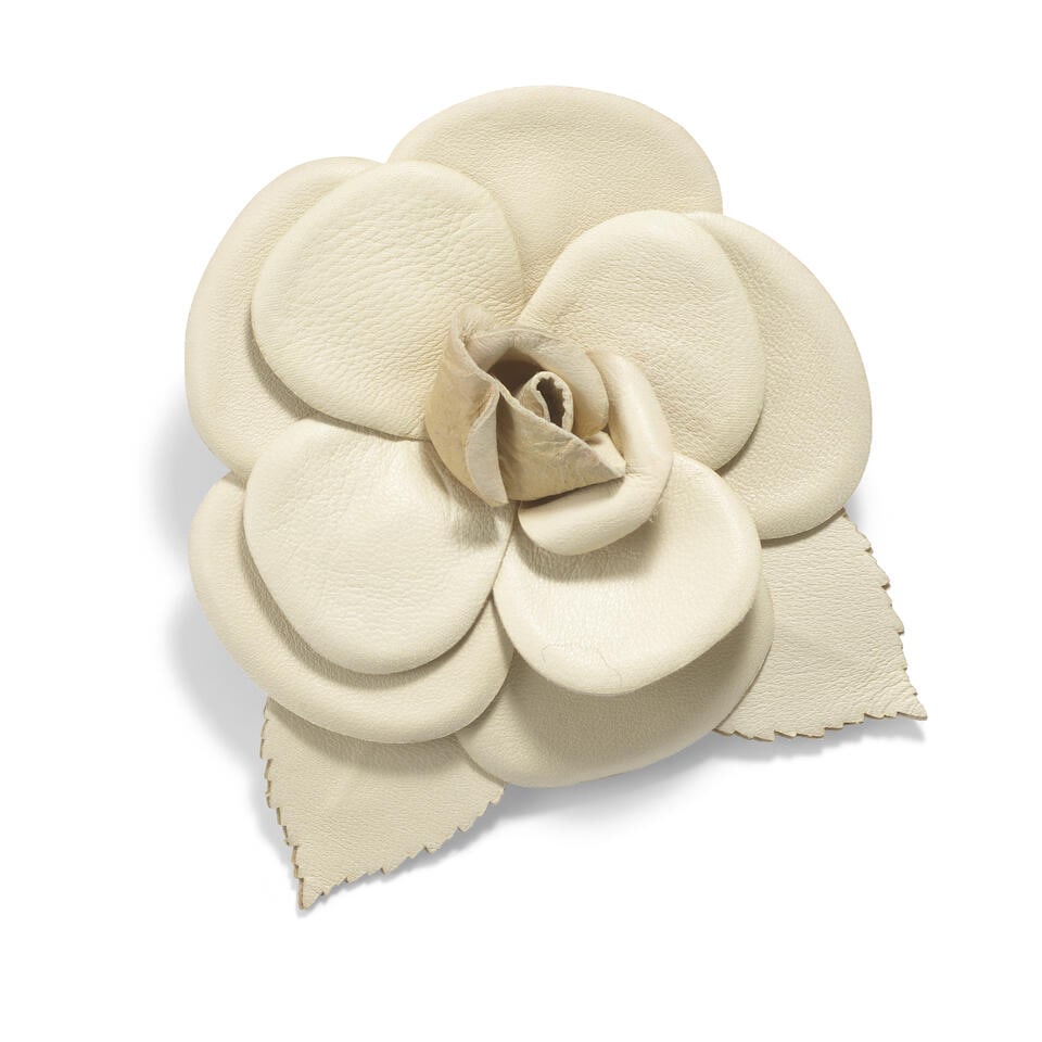 CHANEL: TAUPE LEATHER CAMELLIA BROOCH: CHANEL: TAUPE LEATHER CAMELLIA BROOCH • Measures 8.5 cm x 8.5 cm x 2 cm Footnotes: OVERALL CONDITION: Good | Light signs of wear throughout. Loss of shape at center of flower. The Condition Repo