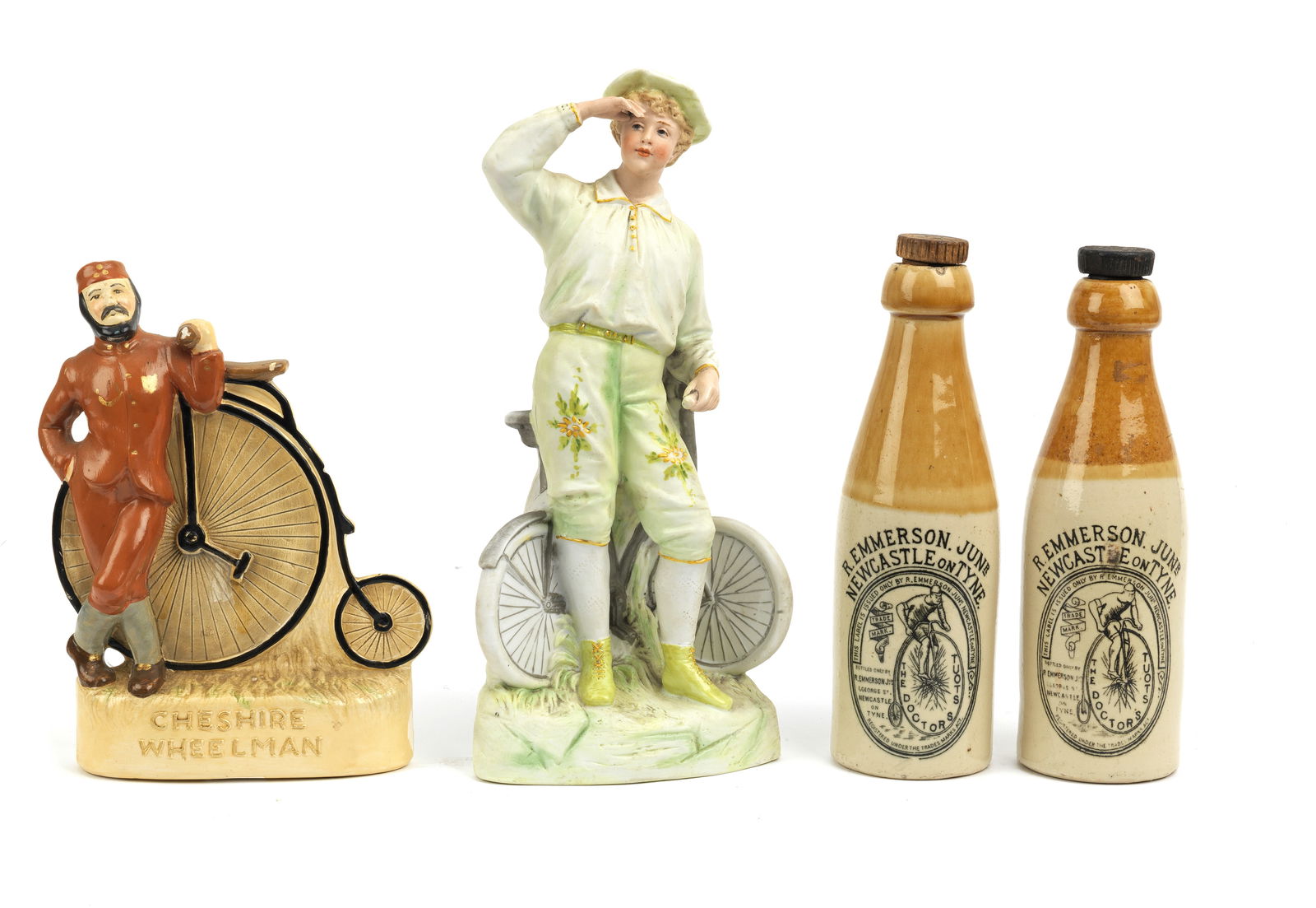 Two cycling ceramics, ((4)): Two cycling ceramics, comprising a Victorian bisque hand-painted gentleman with a safety bicycle, 29cm high; and a 'Cheshire Wheelmen' by Knutsford Penny Figures, 21cm high, together with two stone-wa