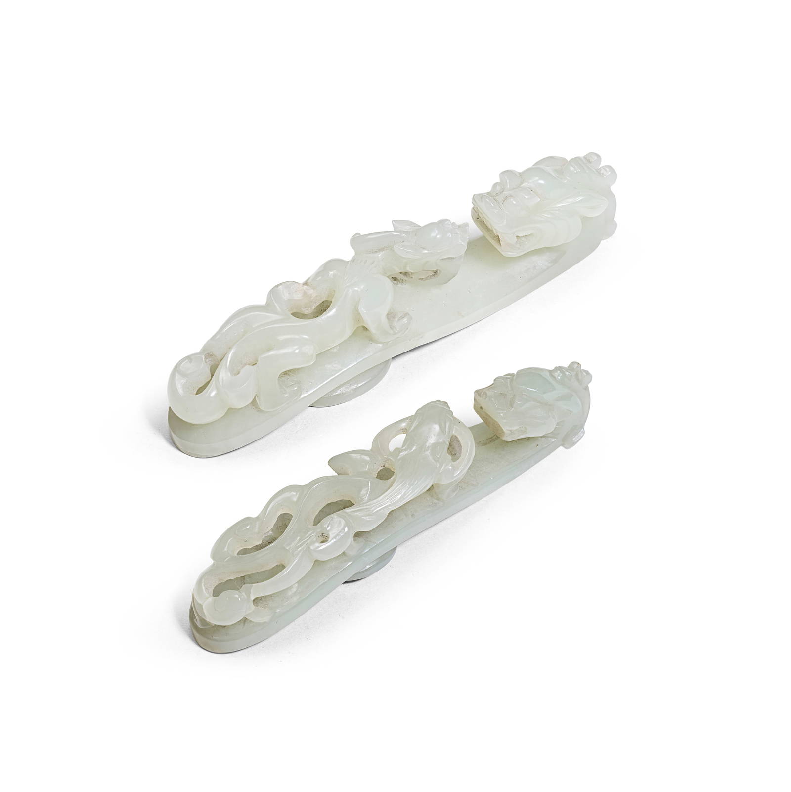 A WHITE JADE AND A PALE GREEN JADE 'CHILONG' BELT HOOK 19th century (2)