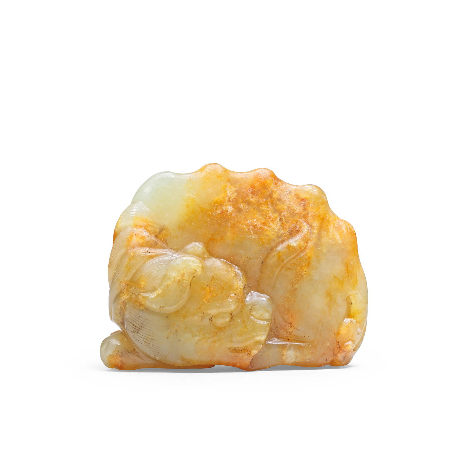 A GREEN AND RUSSET JADE 'RECUMBENT BUDDHIST LION' CARVING Ming Dynasty