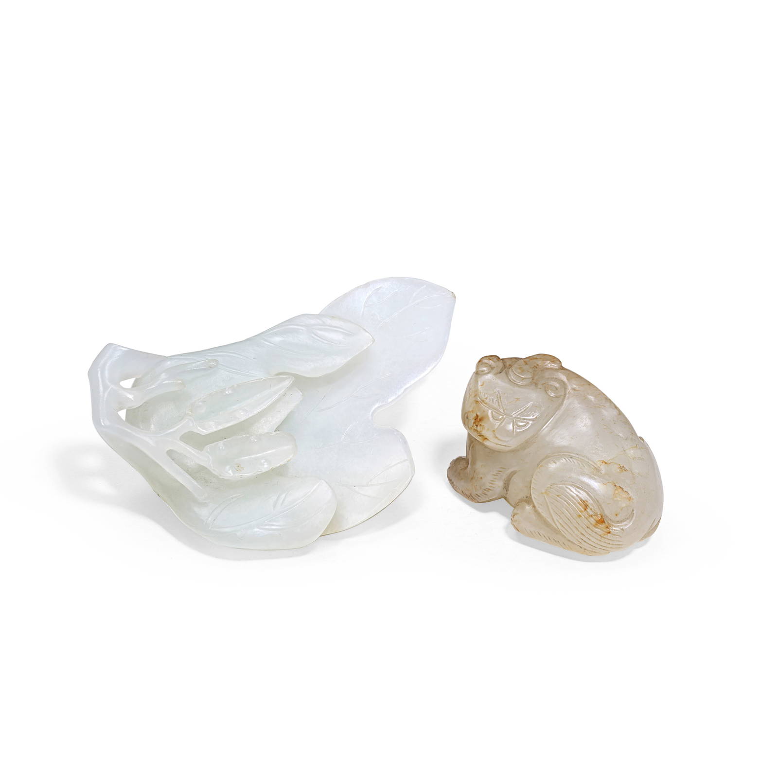 A PALE GREEN AND RUSSET JADE 'LUDUAN' CARVING AND A WHITE JADE 'LEAF' SCOOP 19th/20th century (2)