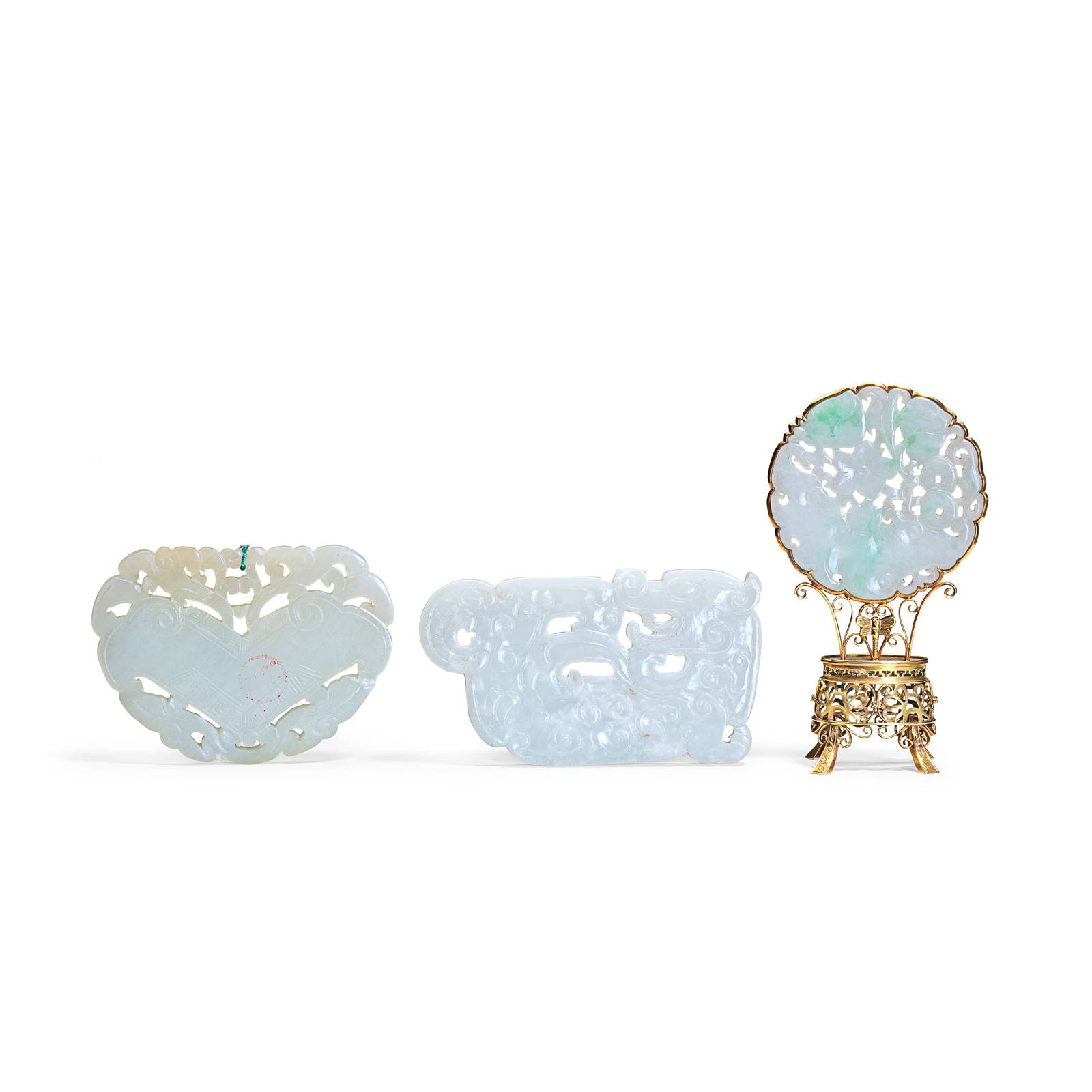 TWO WHITE JADE ARCHAISTIC PLAQUES AND A JADEITE DISC MOUNTED ON A GOLD STAND 19th/20th century (3)