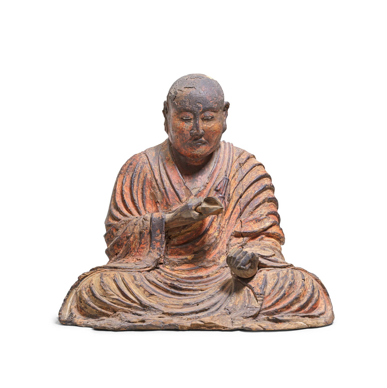 A LACQUERED WOOD FIGURE OF A SEATED BUDDHIST MONK Probably 16th/17th century