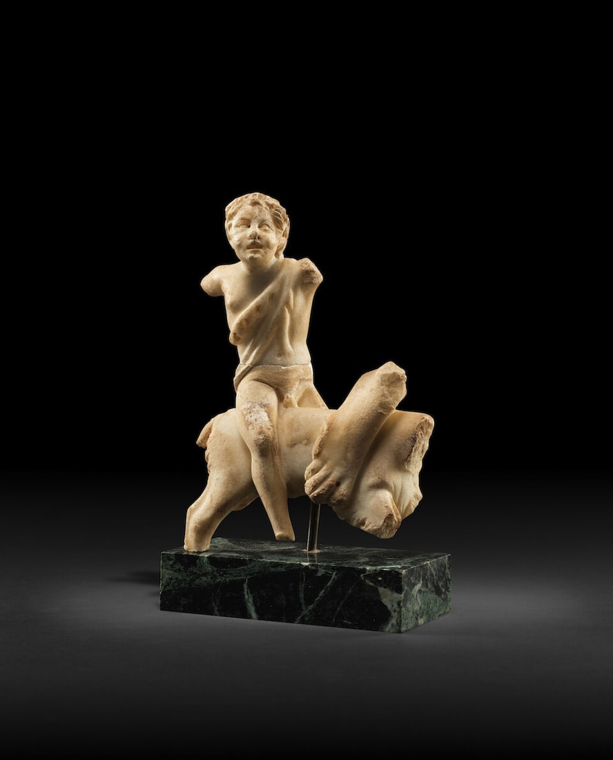 A Roman marble fragment of a satyr riding a goat (1 of 2)