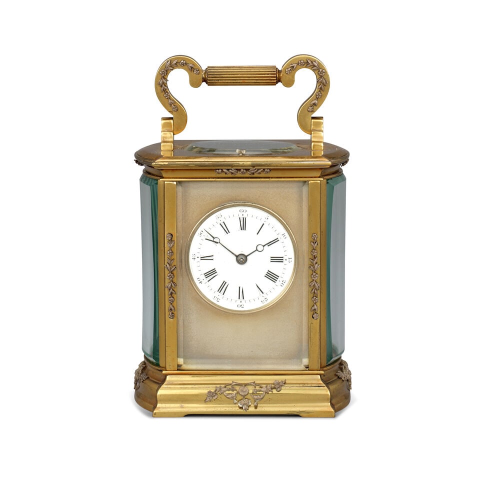 A late 19th century French striking and repeating carriage clock with applied floral decorated m...: A late 19th century French striking and repeating carriage clock with applied floral decorated mounts The case surmounted by a decorated handle over an oval observation window and repeat button to a m