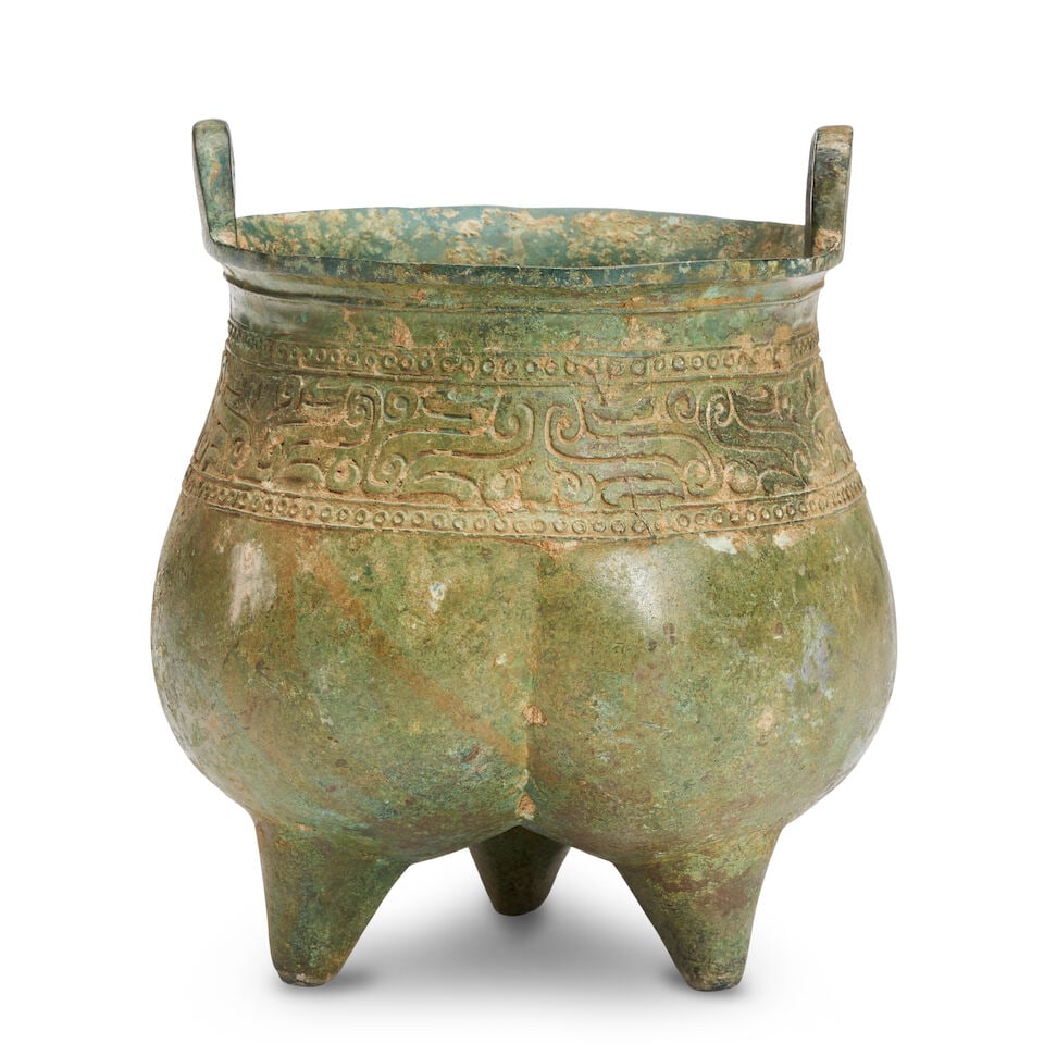A PARCEL-GILT ARCHAIC CAST BRONZE TRIPOD VESSEL, LIDING China, Shang Style, Possibly Ming Dynasty, (1 of 2)