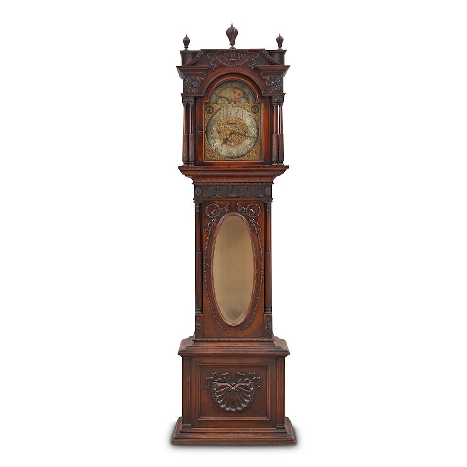 ELLIOTT OF LONDON CARVED MAHOGANY TALL CASE CLOCK WITH NINE TUBES England, 20th cnetury,: ELLIOTT OF LONDON CARVED MAHOGANY TALL CASE CLOCK WITH NINE TUBES England, 20th cnetury, the architectural carved mahogany case with the hinged door fitted with an oval glass window and flanked by pai