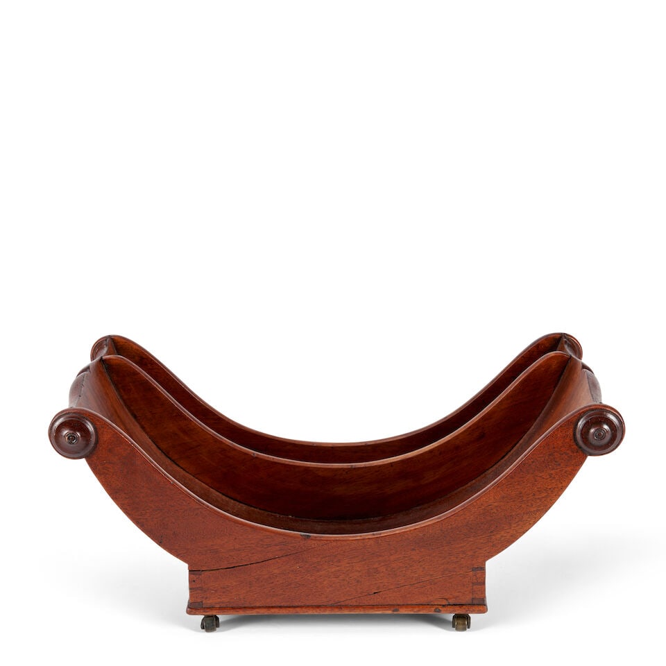 A GEORGIAN MAHOGANY CHEESE COASTER England, 19th century,: A GEORGIAN MAHOGANY CHEESE COASTER England, 19th century, boat-form, on casters, wd. 16 3/4, dp. 9 1/8, ht. 7 1/8 in. Footnotes: OVERALL CONDITION: Wear consistent with age and use, including cracks,