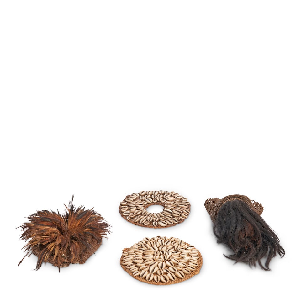 TWO AFRICAN COWRIE SHELL ROUNDELLS AND TWO FUR HEADDRESSES (1 of 2)