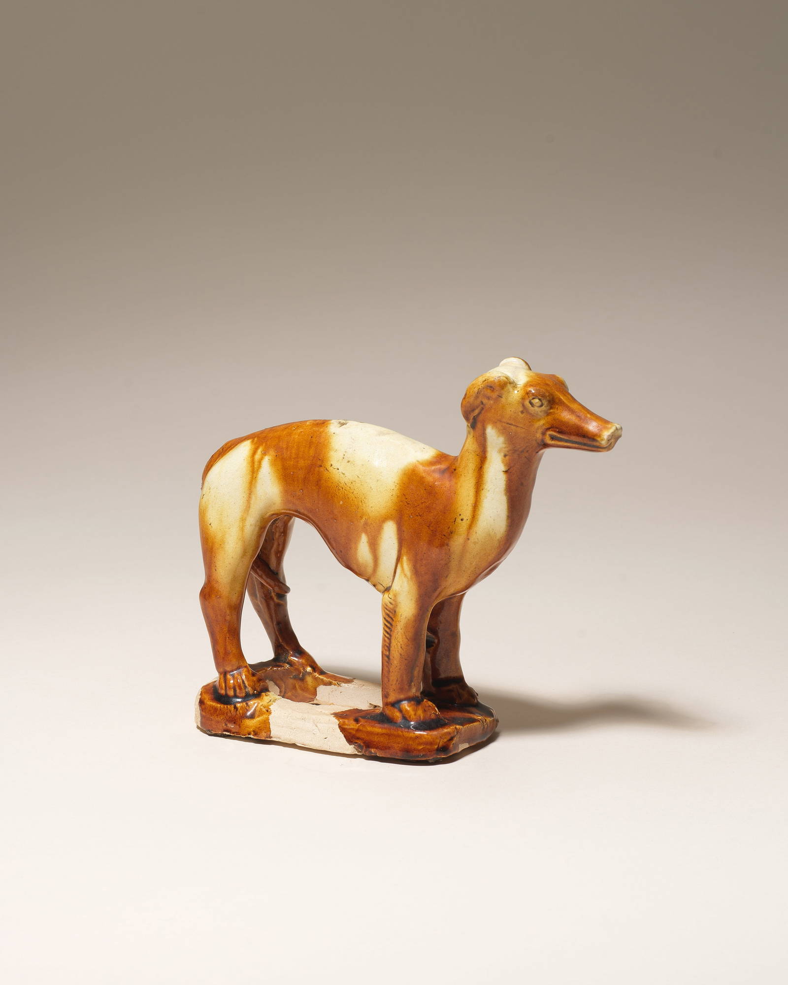 A RARE AMBER AND STRAW-GLAZED POTTERY FIGURE OF A SIGHTHOUND Tang Dynasty (2)