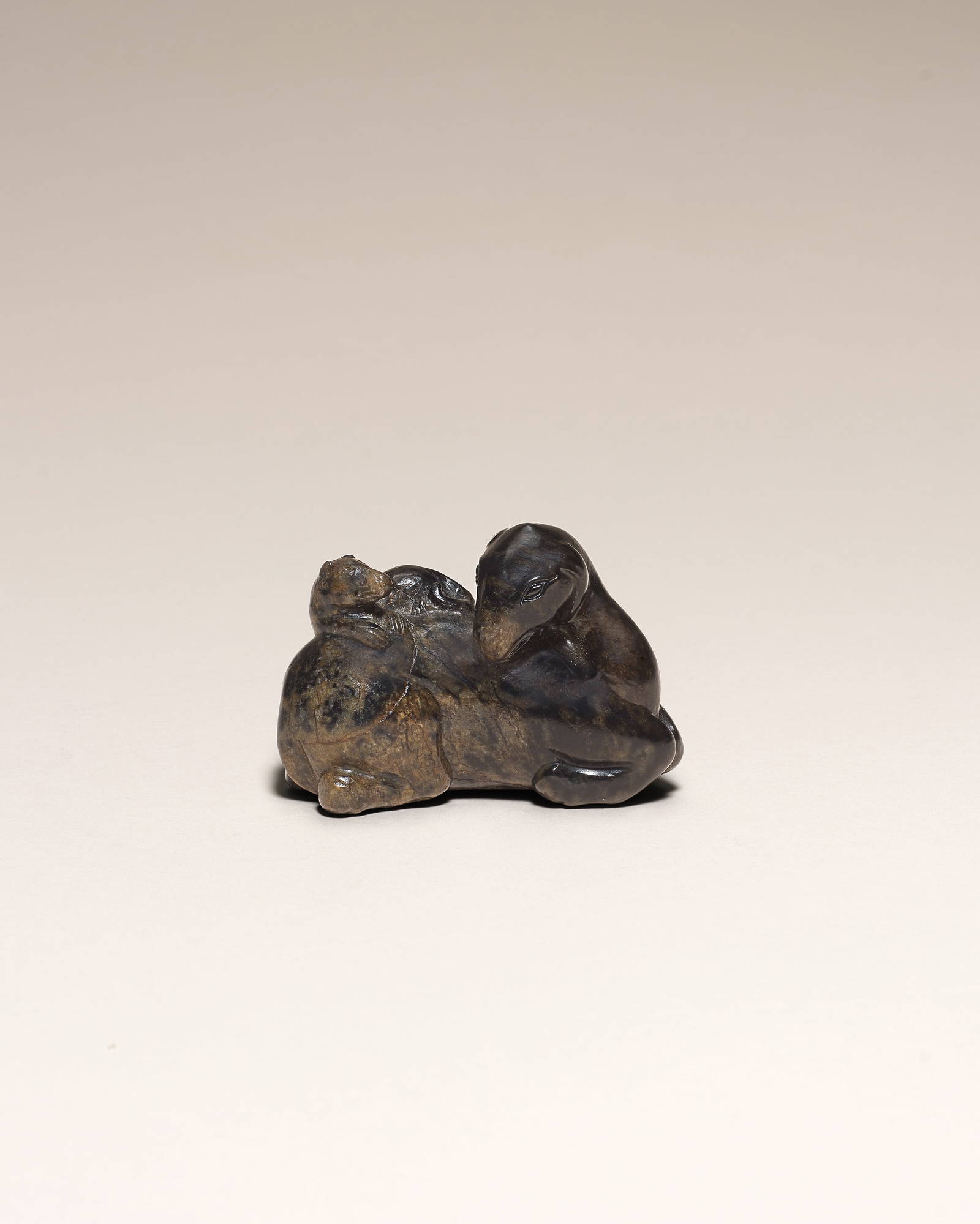 A RARE BLACK AND BROWN JADE 'CAMEL AND BADGER' GROUP Song/Ming Dynasty (3)