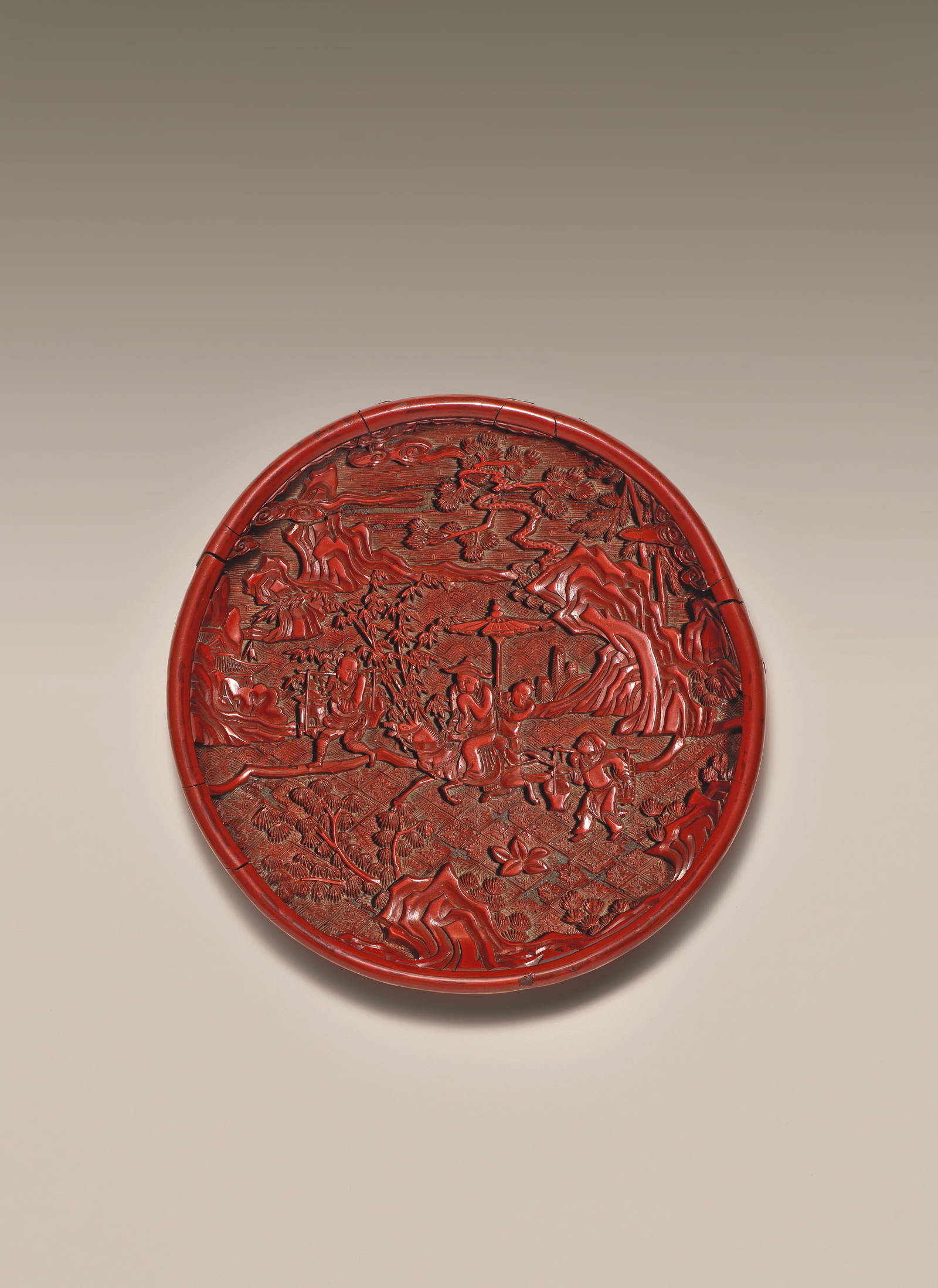 A RARE CARVED CINNABAR LACQUER 'RIDING SCHOLAR' DISH Yuan/early Ming Dynasty (2)