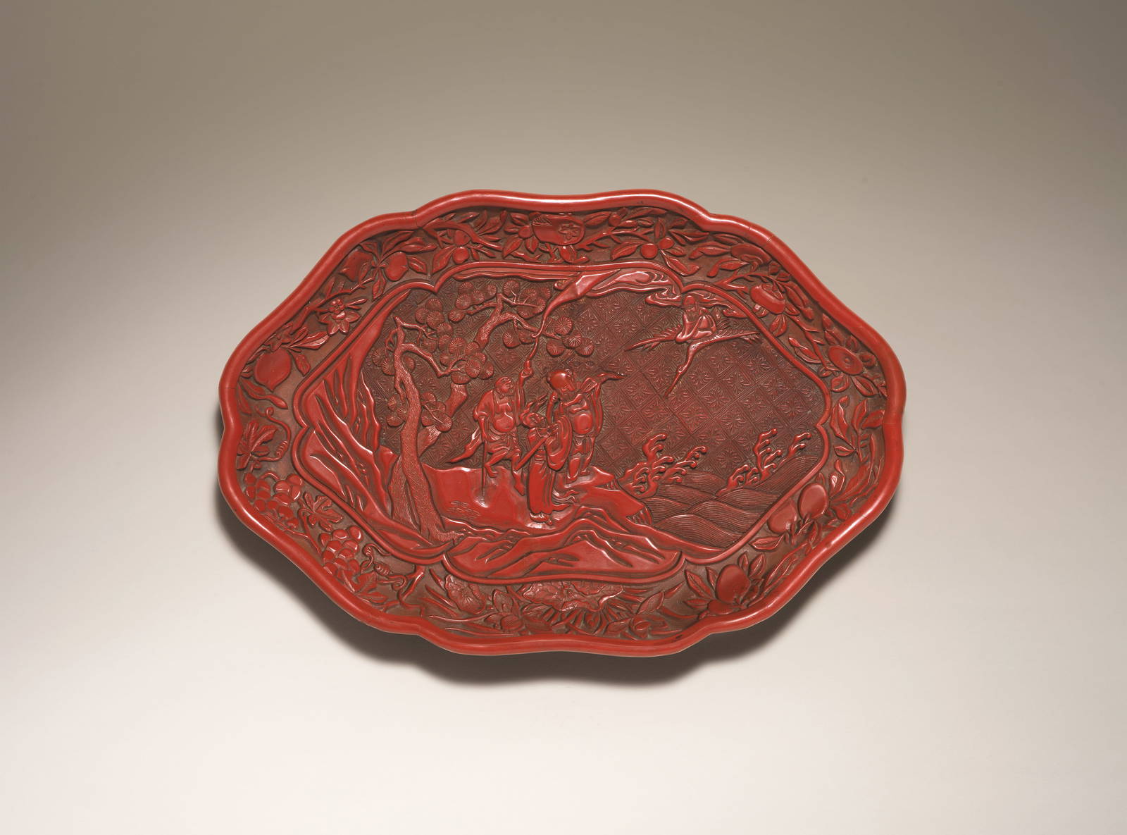 A CARVED CINNABAR LACQUER 'DAOIST IMMORTALS' TRAY 16th century