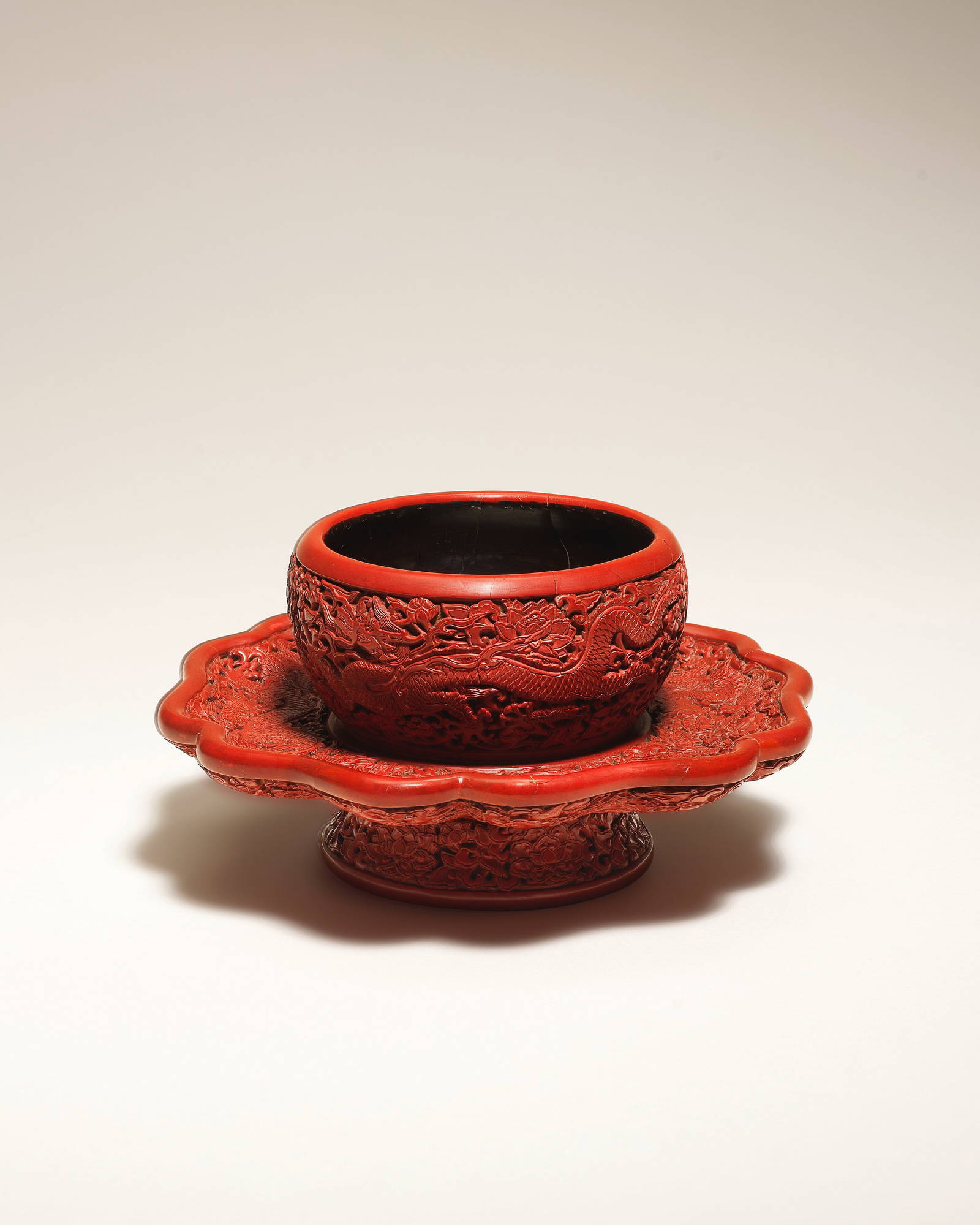 AN IMPORTANT AND EXCEPTIONALLY RARE CARVED CINNABAR LACQUER 'DRAGON' BOWL STAND Yongle six-chara...