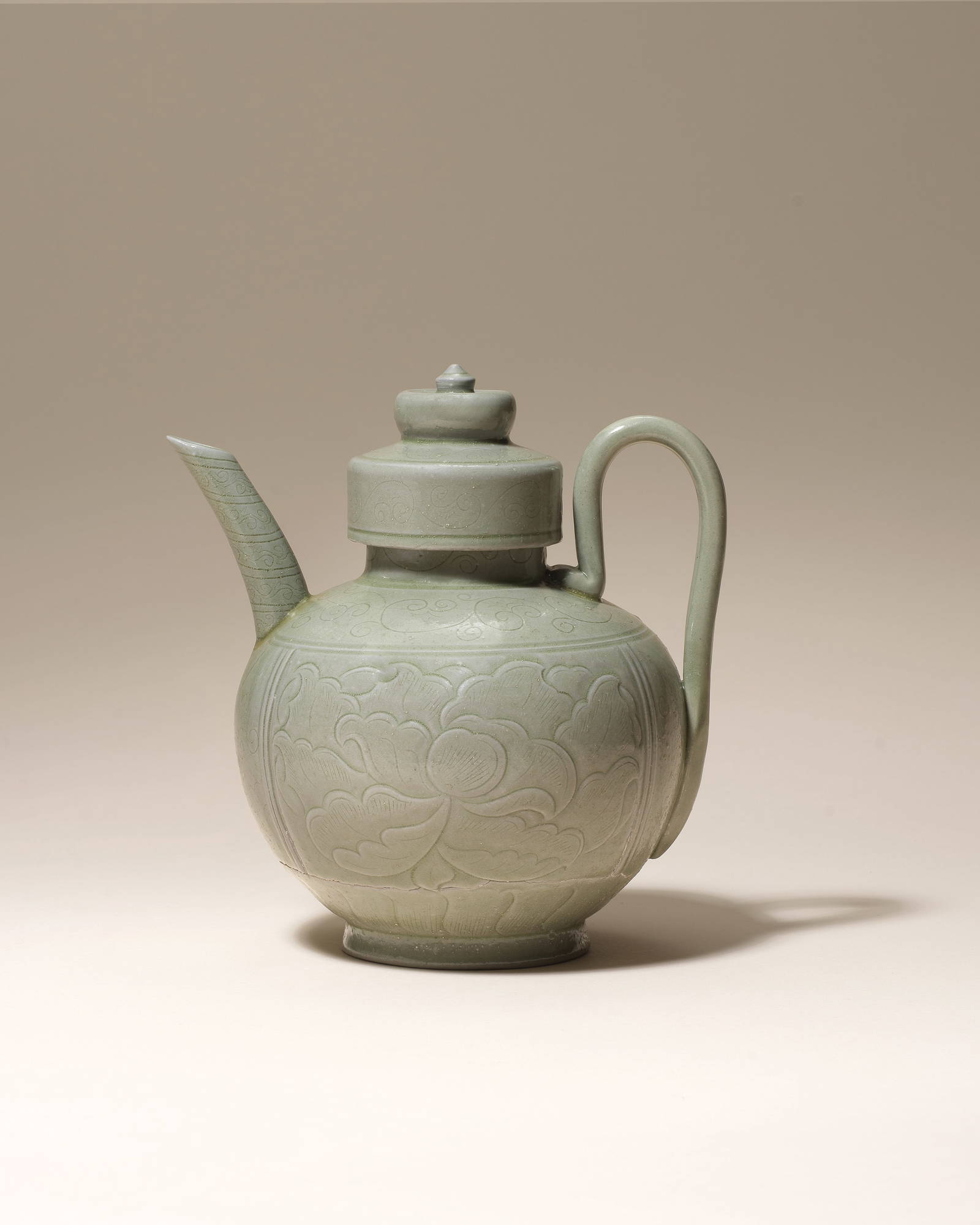 A VERY RARE YUEYAO CARVED AND INCISED CELADON-GLAZED 'PEONY' EWER AND COVER Northern Song Dynast...