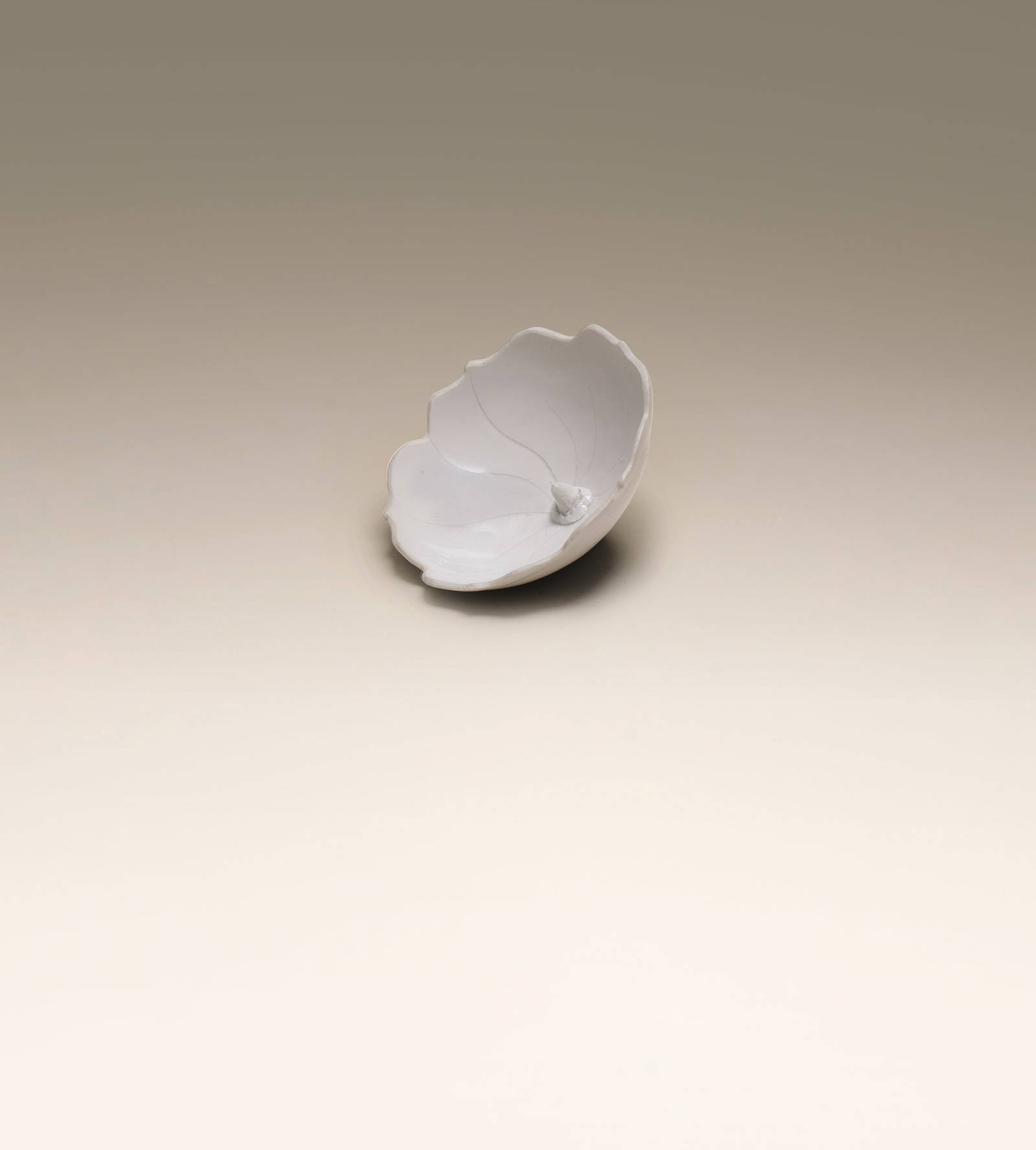 A VERY RARE DINGYAO HIBISCUS-SHAPED LIBATION CUP Five Dynasties/early Northern Song Dynasty, 10t...