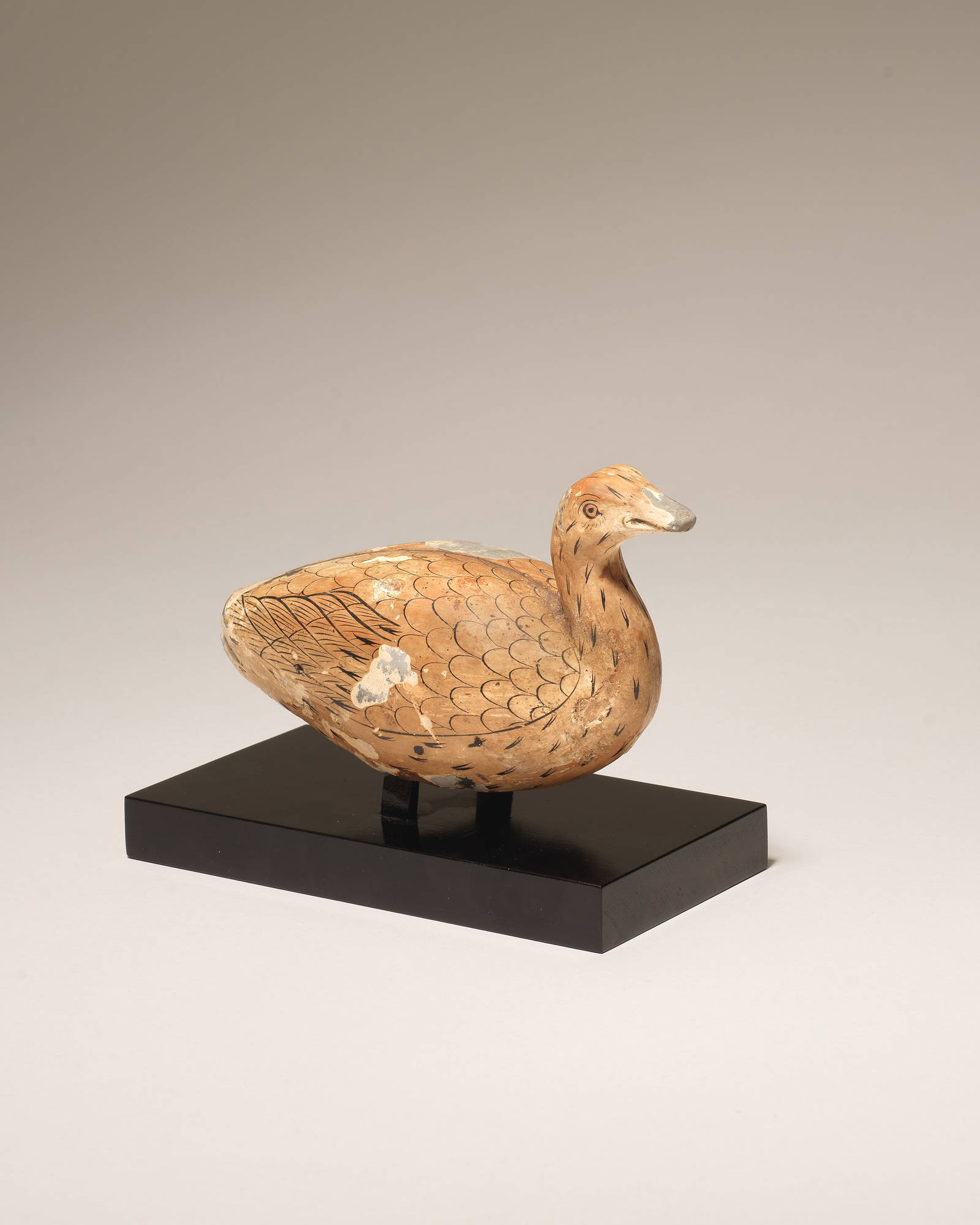 A VERY RARE LACQUER-PAINTED POTTERY FIGURE OF A WILD DUCK Warring States Period/Western Han Dyna...