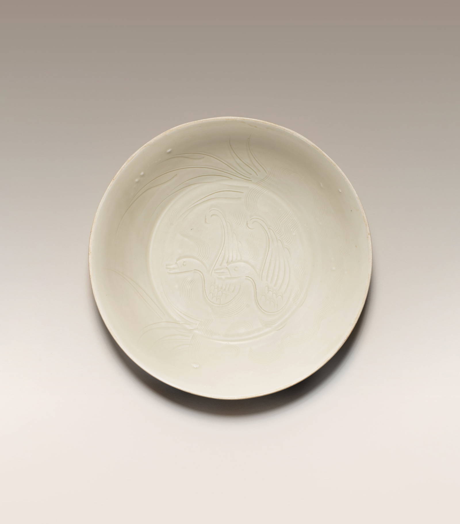 A DINGYAO WHITE-GLAZED 'MANDARIN DUCKS' DISH Northern Song/Jin Dynasty, 12th century (2)